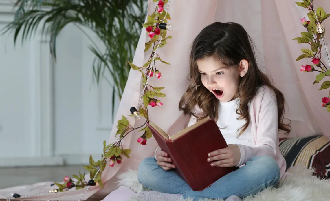 cute girl reading book around cute decoration